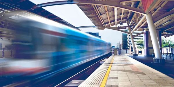A speeding train going through a station , the train is going so fast its image is blurred