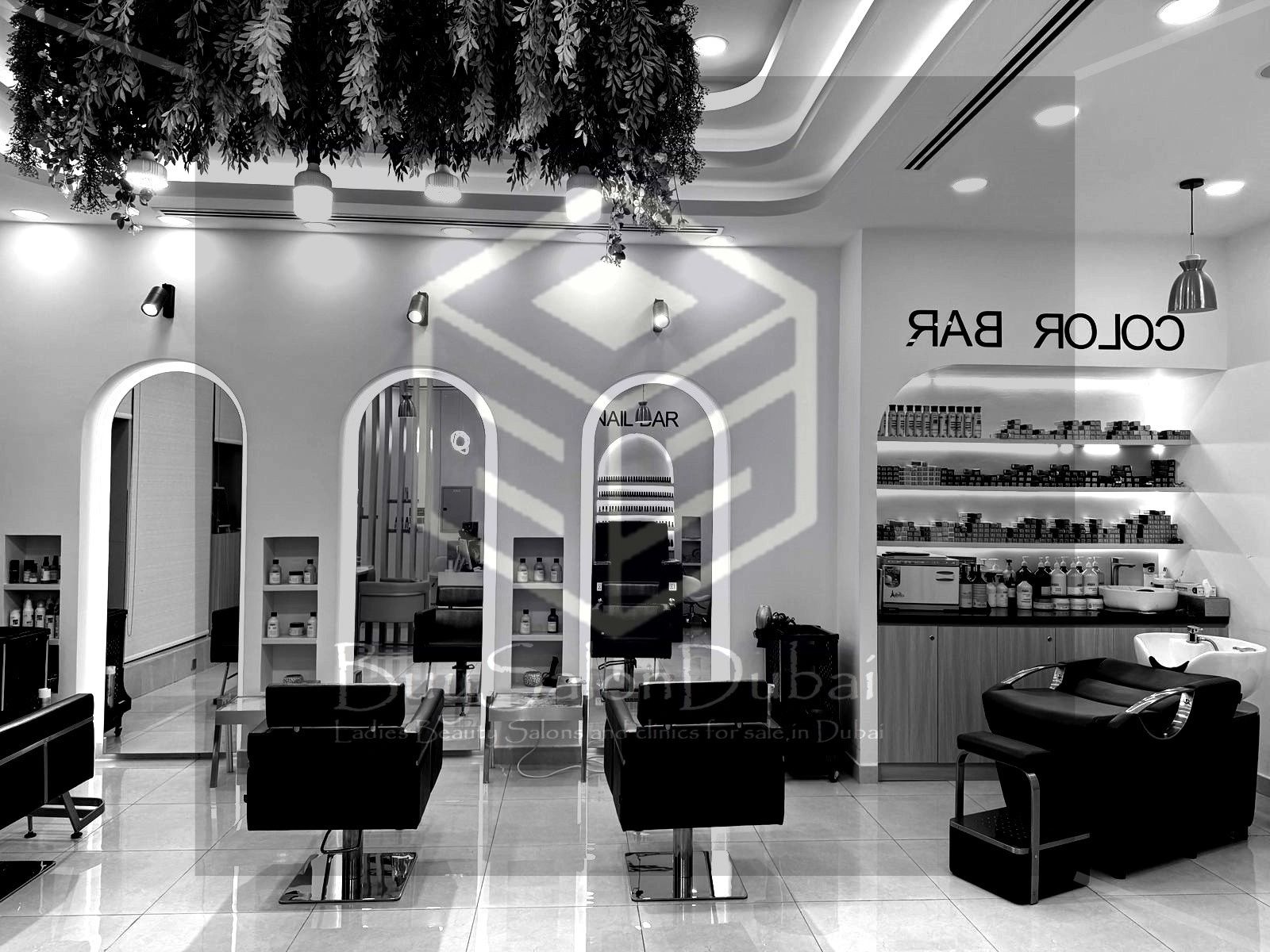 Modern beauty salon with sleek styling chairs and well-organized shelves.