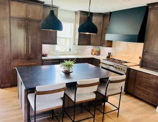Modern kitchen with dark wood cabinetry and large island.