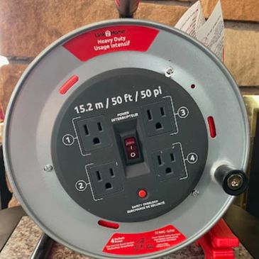 Heavy-duty 50 ft extension cord reel with four outlets and power interrupter switch.