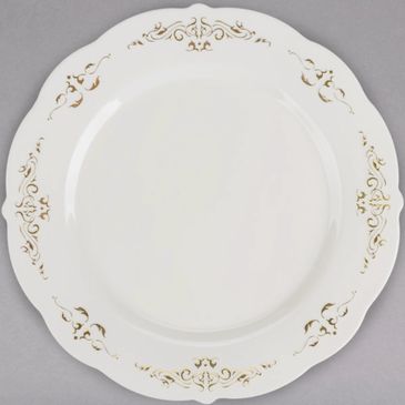 Elegant white plate with gold decorative patterns on scalloped edges.