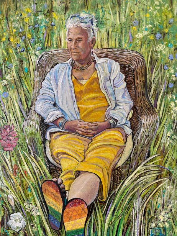 A mature woman rests peacefully in wicker chair in  middle of a meadow's tall grasses and flowers.