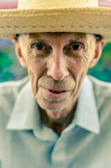 close up photo of an elderly man with haunting eyes with a shallow depth of field