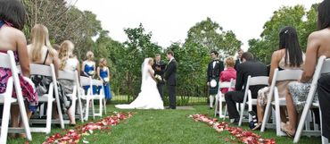 low angle photo of the pastoral wedding ceremony from the center of the aisle