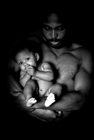 Moody black and white photo of an African-american father and child