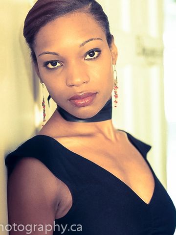  warm toned colour headshot of actress in black dress
