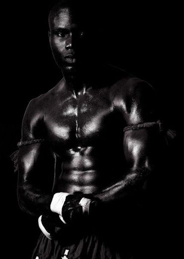 dramatic black and white photo of a Muay Thai champion