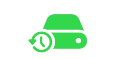 Green backup and restore icon with a clock and hard drive symbol.