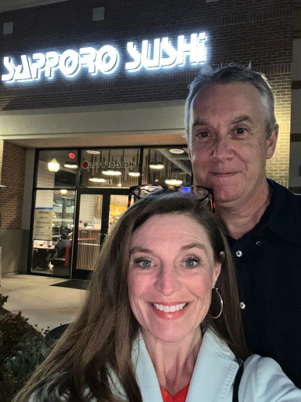 Selfie of Tiffany Boyd-Hodgson and Sandy Hodgson in front of Sapporo Sushi in San Elijo Hills