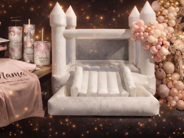 White inflatable castle with birthday candles and balloons in the background.