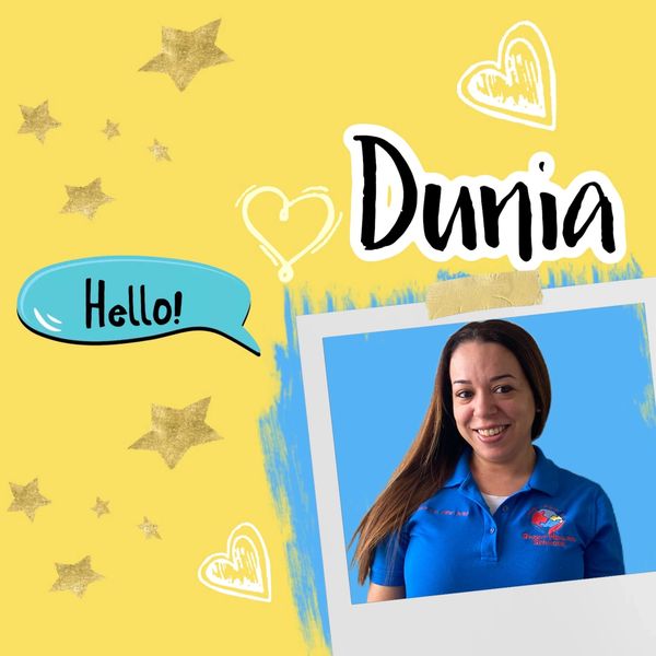 Portrait of Dunia with cheerful greeting on yellow background.