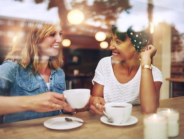 Friends talking over coffee or tea