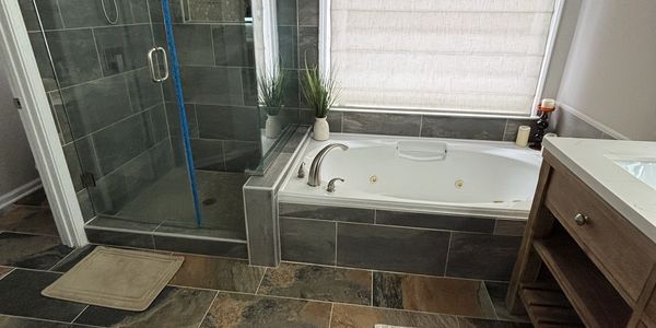 Modern bathroom with bathtub and glass shower.