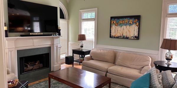Cozy living room with beige sofa and fireplace.