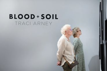 two women looking at gallery photogrpahs