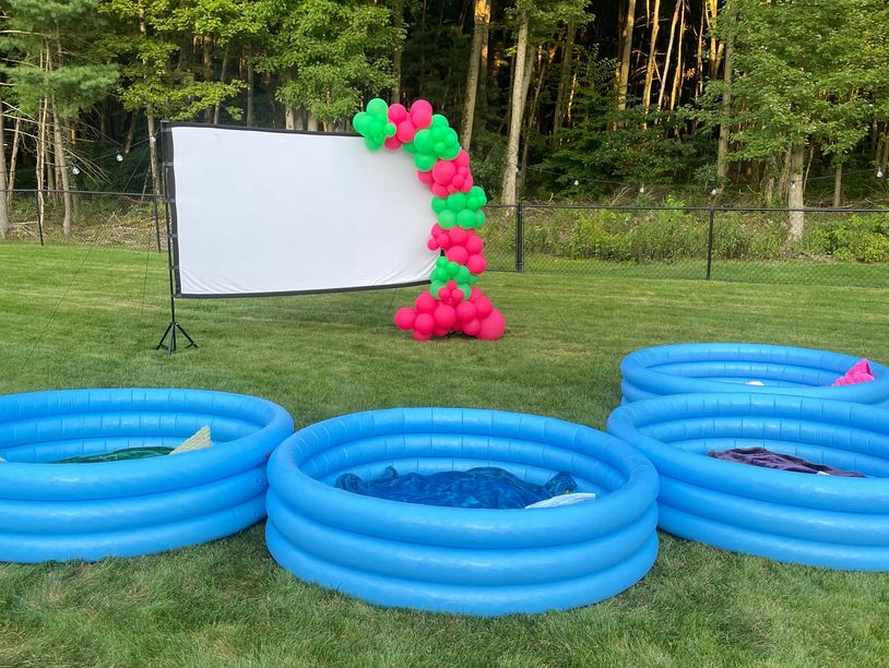 Backyard movie night with screen and pools