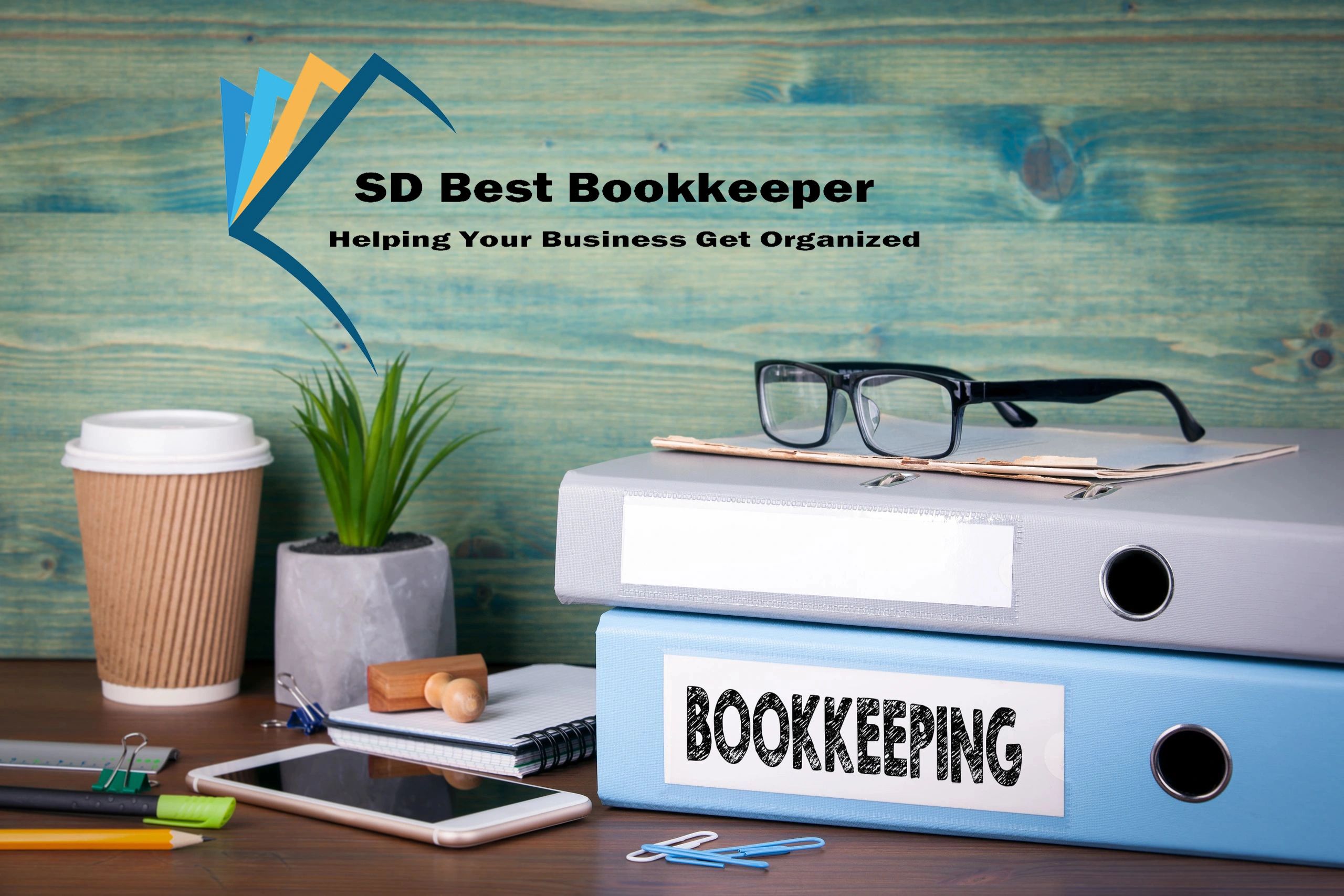 Office desk setup with bookkeeping files, glasses, and accessories.