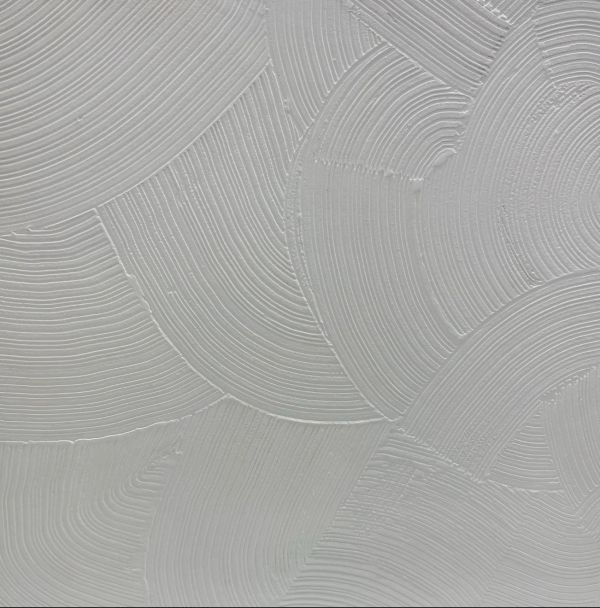 Close-up of textured gray plaster wall.