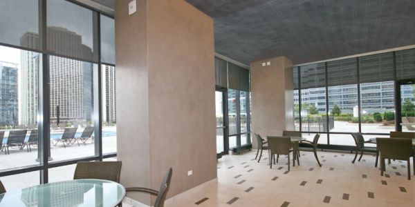 Modern indoor seating area with large windows and city view.