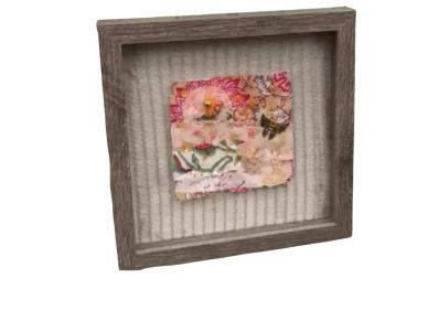 Framed textile art with a floral design.