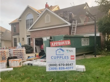 Sign for Cupples Construction in front of a house getting a new roof 