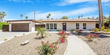 Single-story house with desert landscaping and a two-car garage.