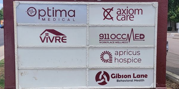Signboard of American Professional Plaza with medical and wellness services.