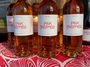 Bottles of Pink Ensemble rosé wine on a table.