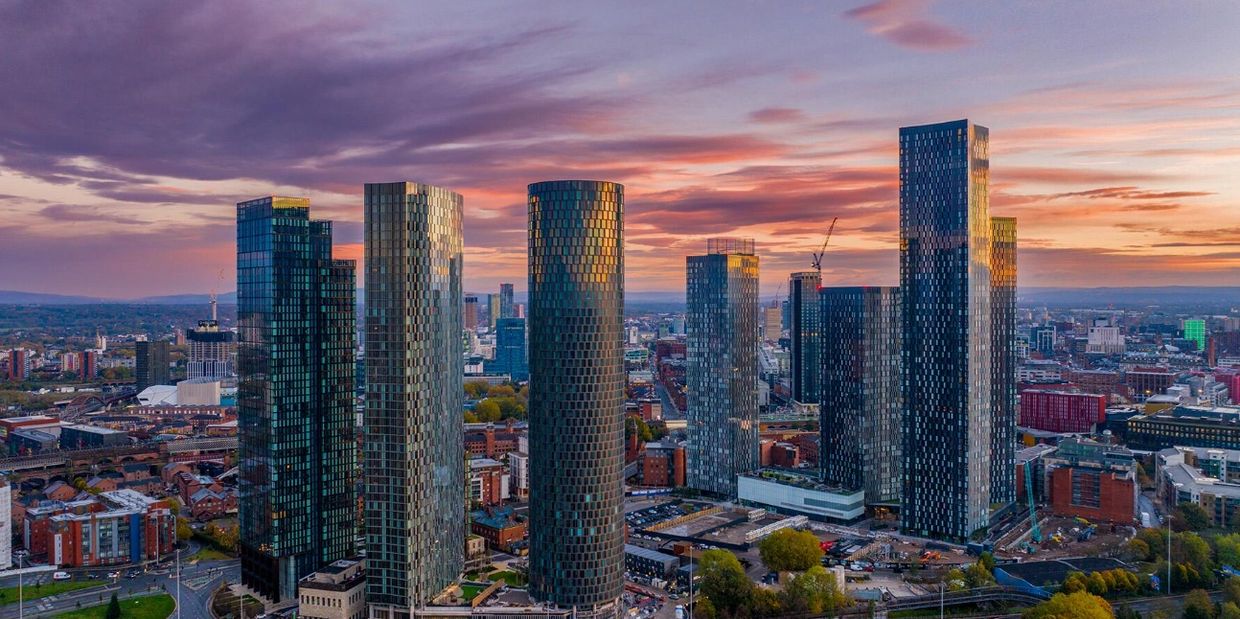 Skyline of modern skyscrapers at sunset.