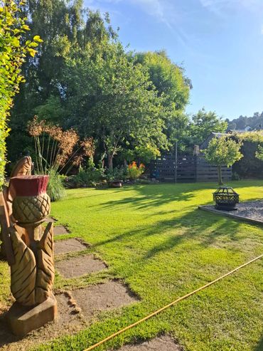 carved wooden thistle in garden