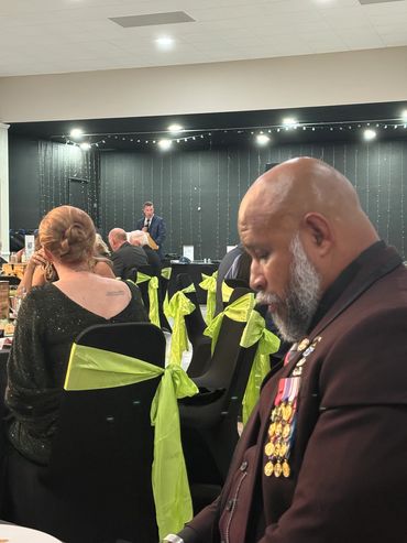 Man with medals at a formal event.