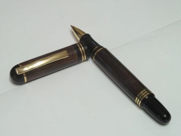 Churchill style rollerball made with cocobolo barrels and 24kt gold trim and fittings.