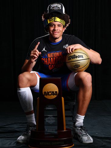 Basketball player celebrating NCAA championship win.