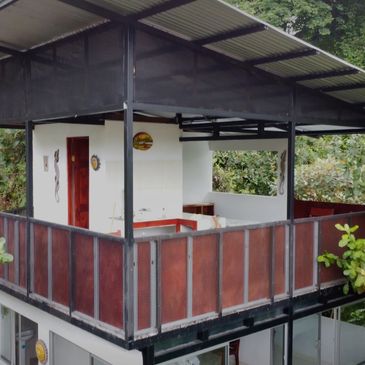 Elevated balcony with wooden panels and a roof.