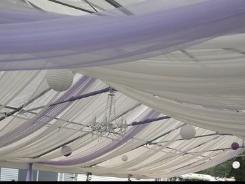 Purple and white draping for wedding event. Additional for chandelier and lanterns.