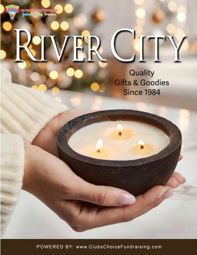 Hands holding a lit three-wick candle with festive blurred lights in the background.