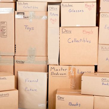 Boxes from a house move with written labels