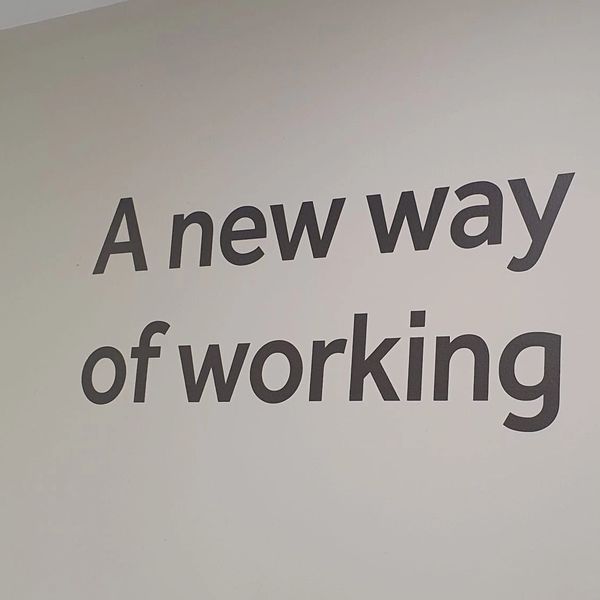 Text on wall saying 'A new way of working'.