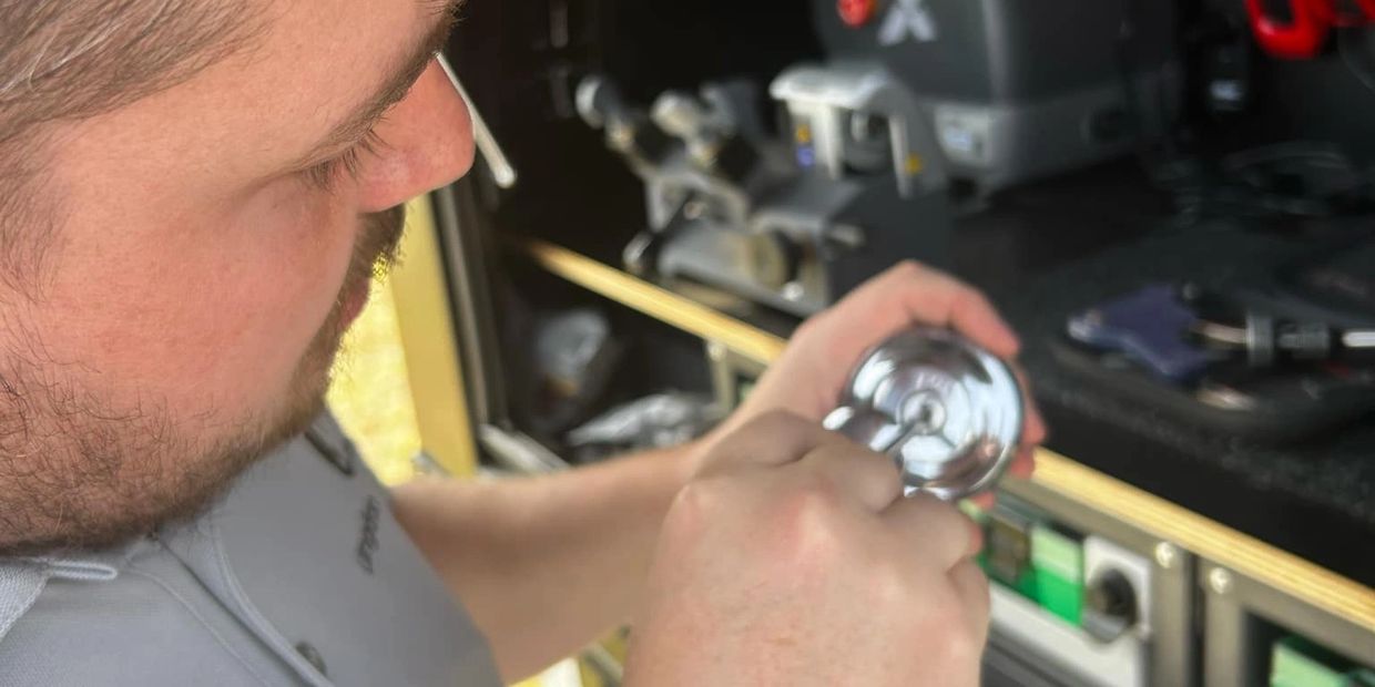Dylan from Langdon Locksmiths working on a yamaha motorcycle petrol cap to create a new set of keys.