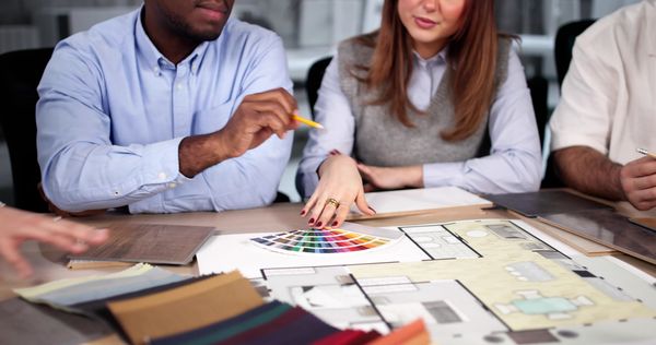 This image shows a close-up view of a group of people, likely designers or clients, collaborating.