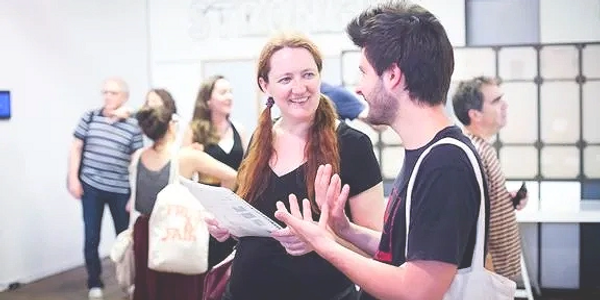 Two people talking at a gallery opening, Third Streaming, Lower East Side, NY City. Yona Backer. 