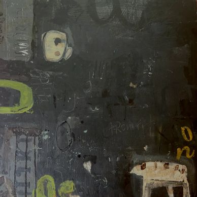 Abstract wall art with dark background and scattered colorful shapes and symbols.