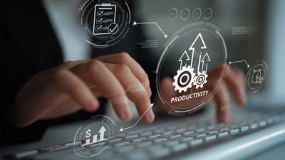 Hands typing on a keyboard with productivity and growth icons overlaid.