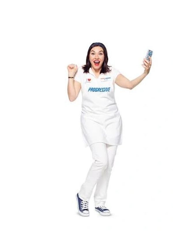 Excited woman in Progressive apron holding a phone.