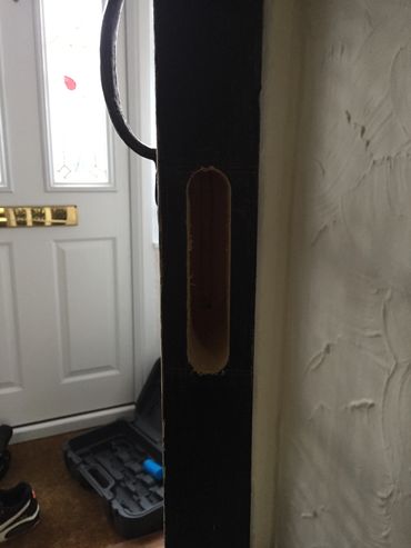 Black open door with hole where lock should be