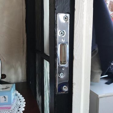 Black open door showing lock