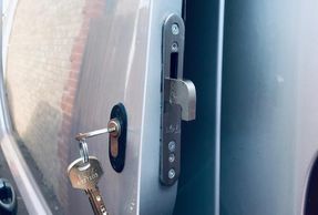 Silver open van door showing lock and keys