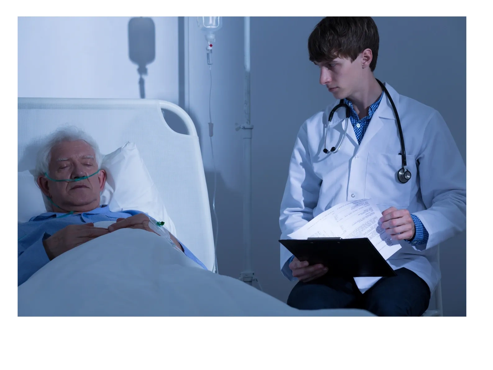 a doctor sitting near a patient on bed 