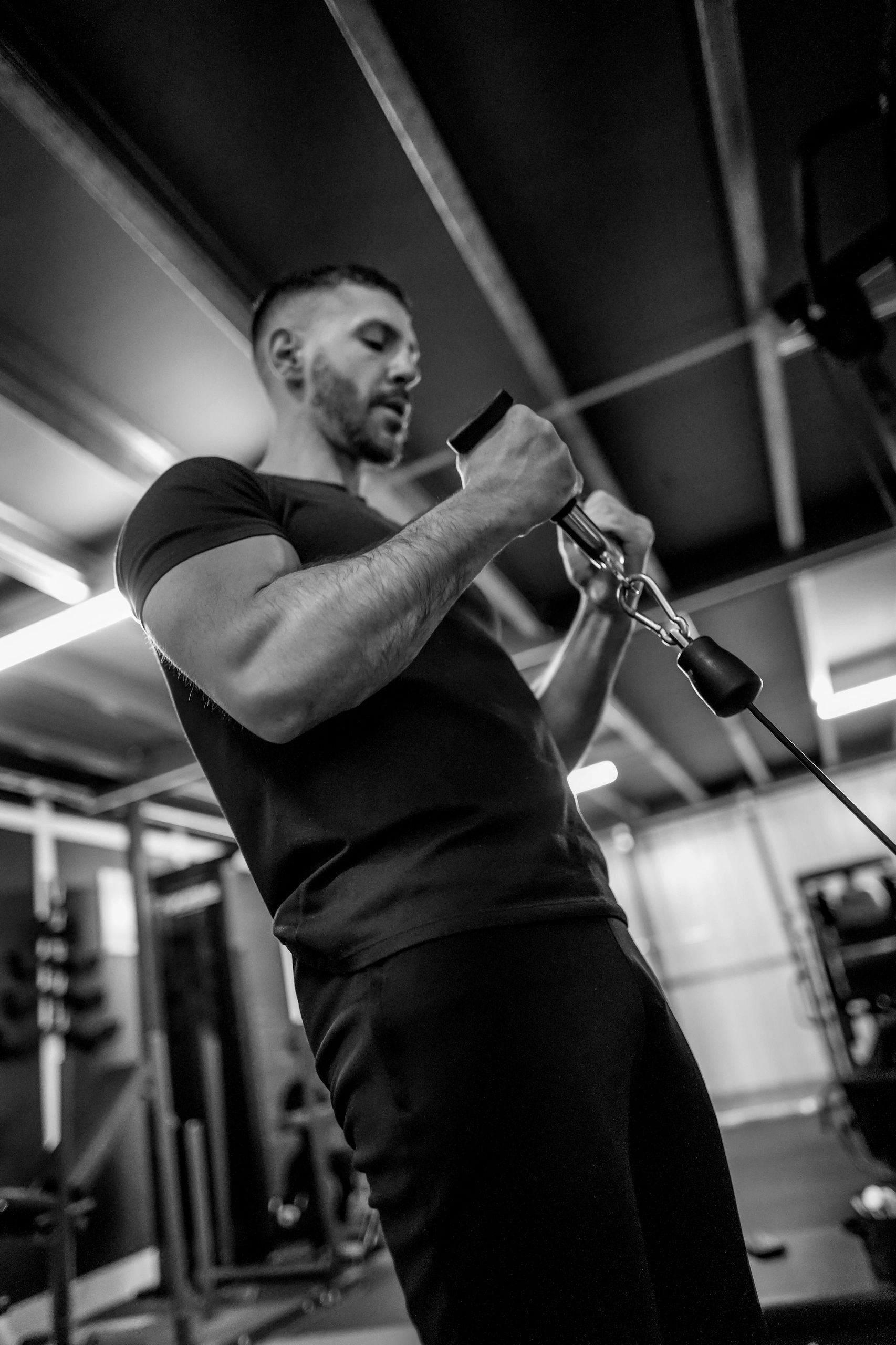 Alexandros training with a cable machine in the gym.
