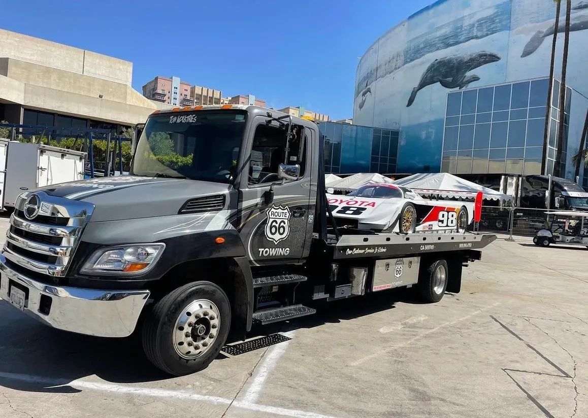 Tow truck with vehcile on flat bed